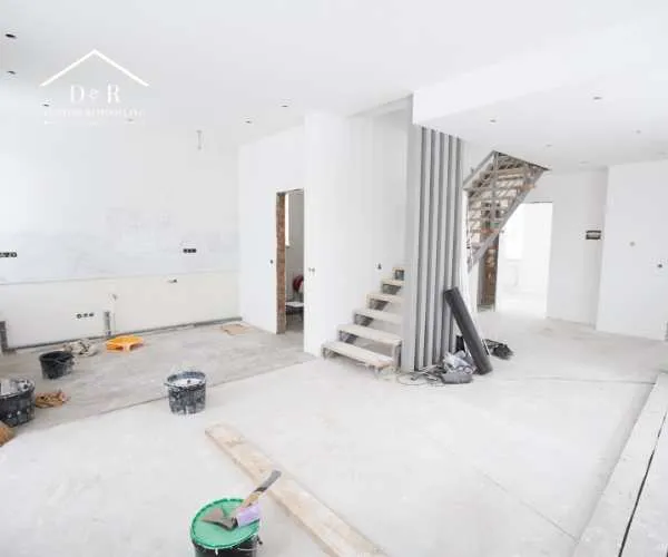 An open-concept home interior undergoing active renovation