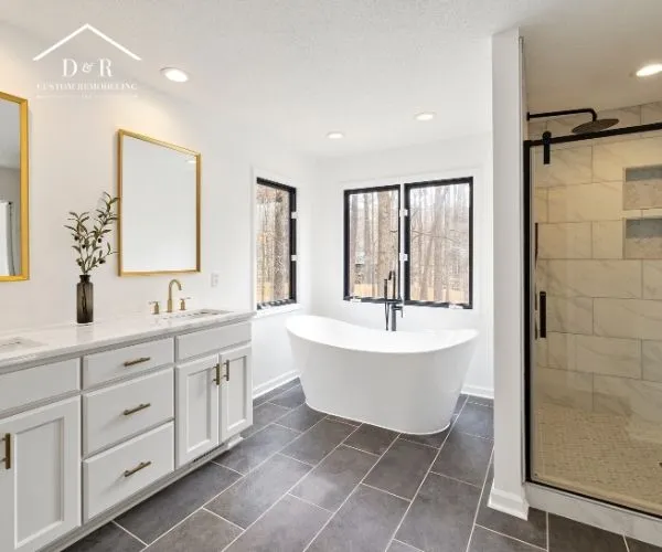 freestanding soaking tub, dark tile floor, and a walk-in glass shower, showcasing bathroom remodeling in Austin TX
