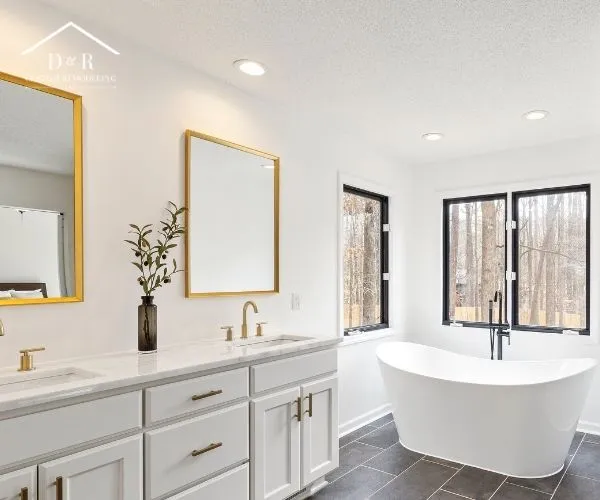 freestanding soaking tub, dark tile floor, and a walk-in glass shower, showcasing bathroom remodeling in Austin